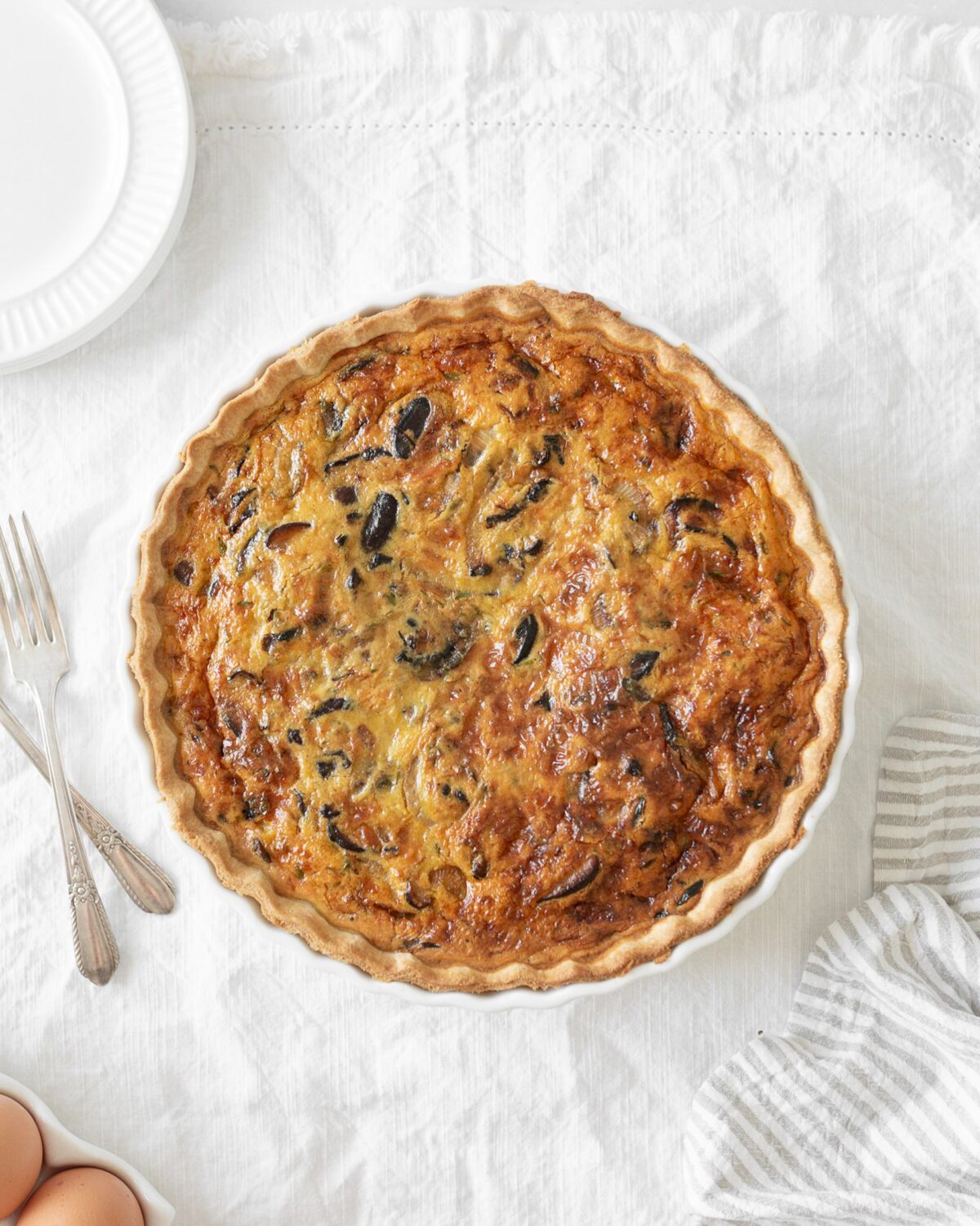 Caramelized Onion and Mushroom Quiche baked in a tart pan.