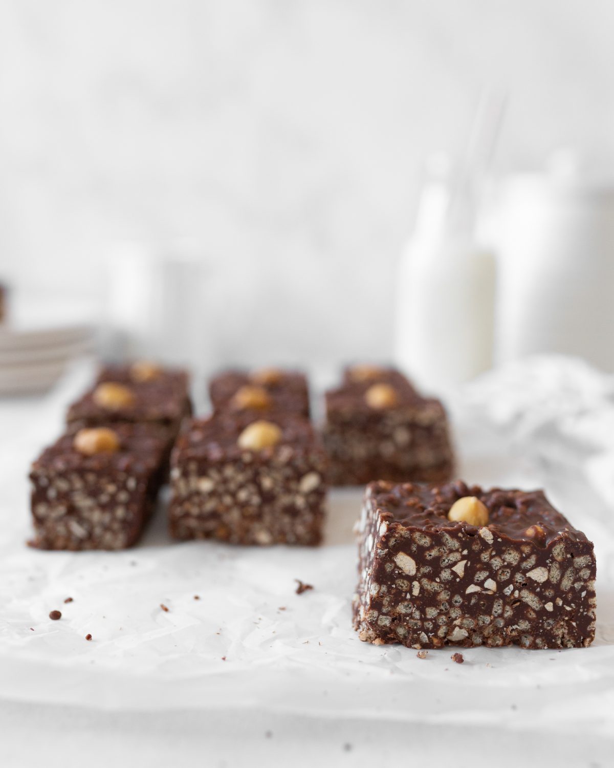 Chocolate Hazelnut Crunch Bars cut on parchment paper.