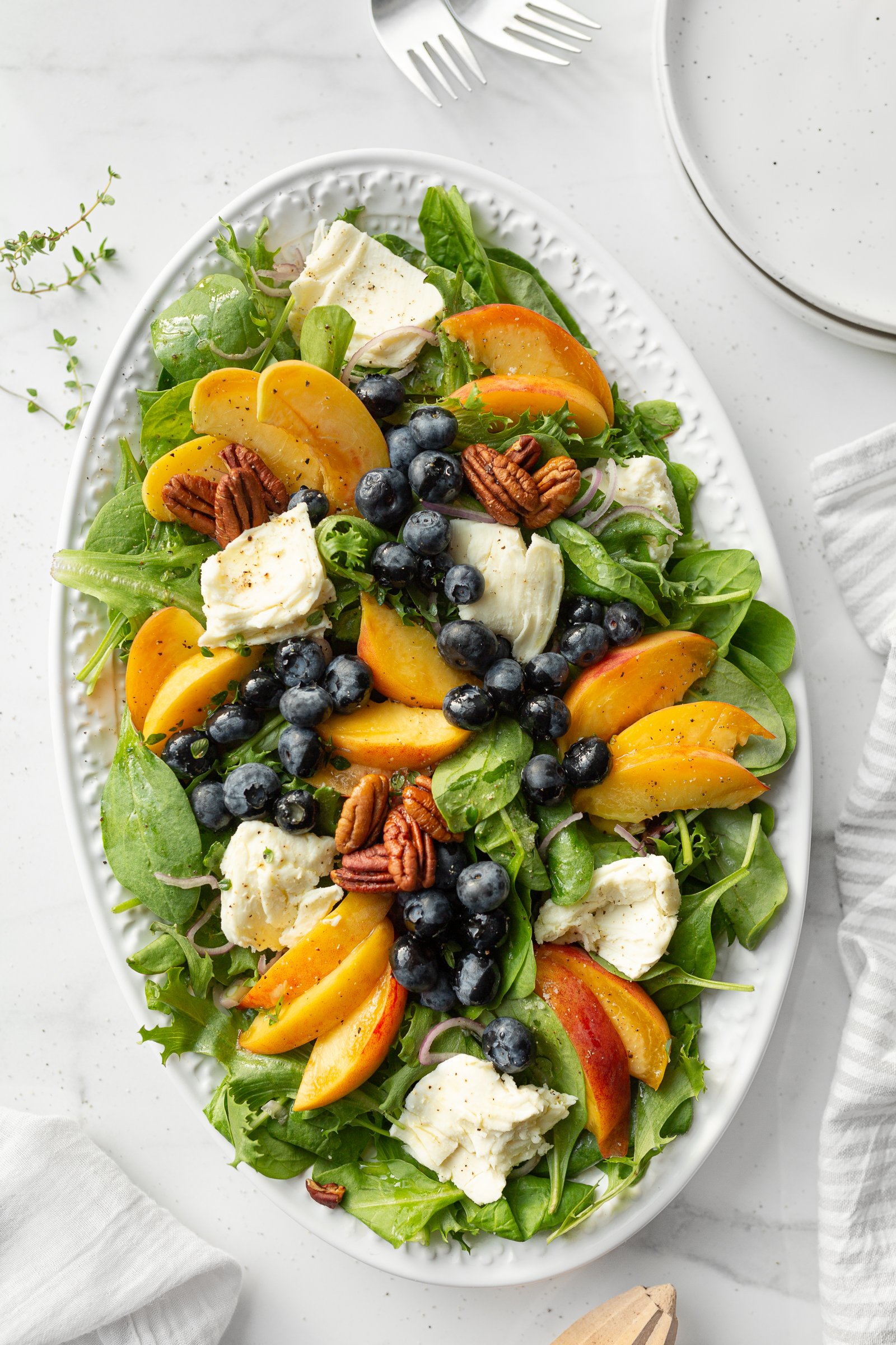 Peach, Blueberry and Mozzarella Salad plated on a large platter.