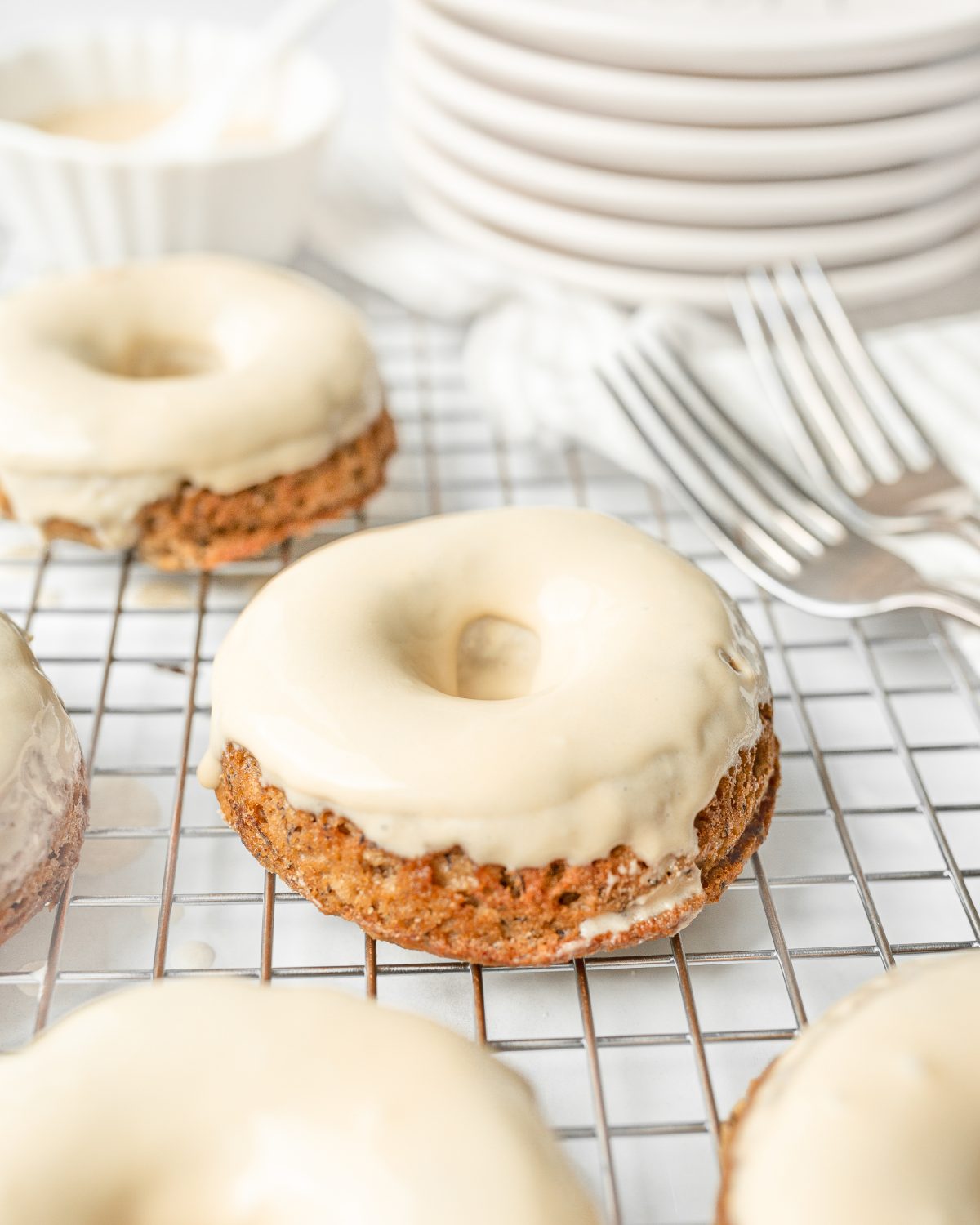 Gluten Free Banana Bread Donuts dipped in maple glaze.
