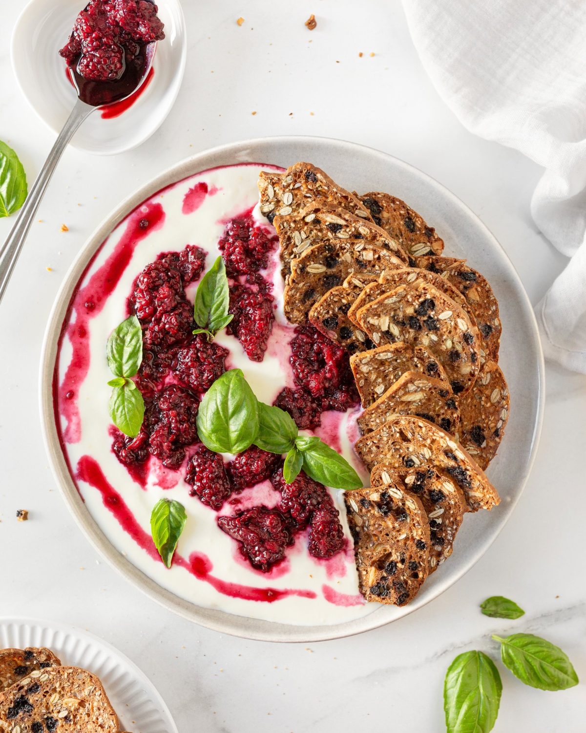 Whipped Goat Cheese with Blackberries plated with crackers.