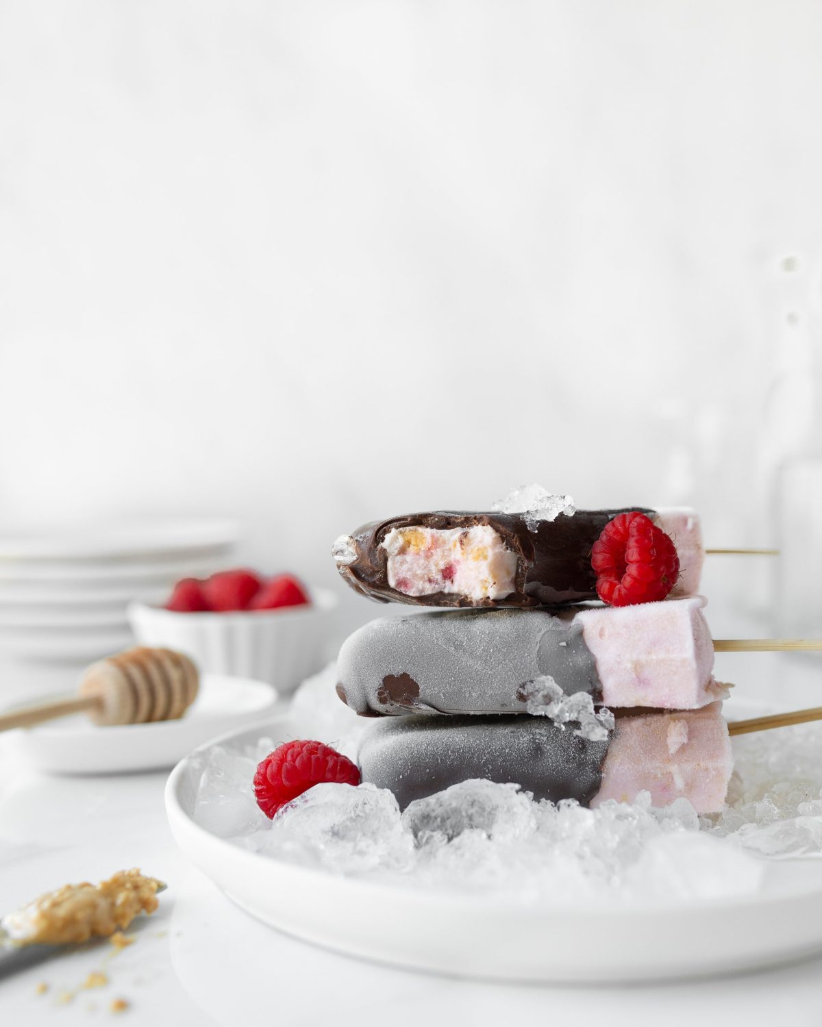 PB and J Frozen Yogurt Bars stacked on a plate with ice.