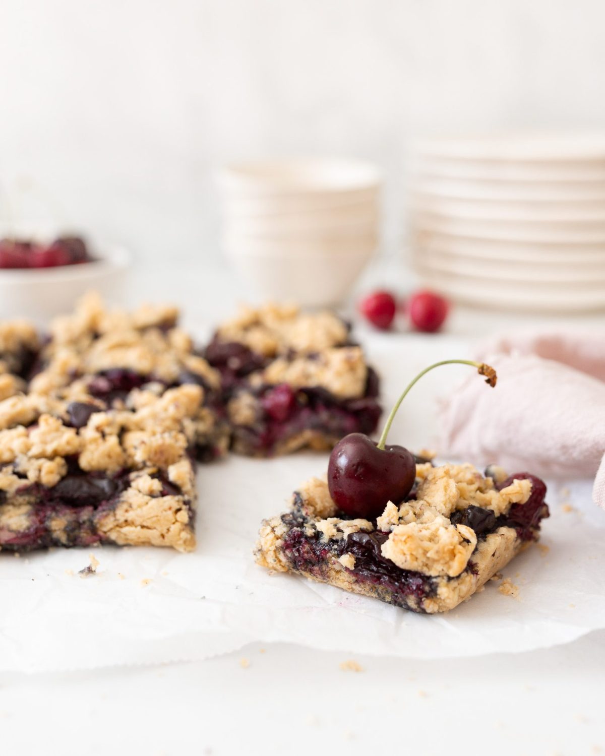 Gluten-free Cherry Crumble Bars on parchment (straight on)