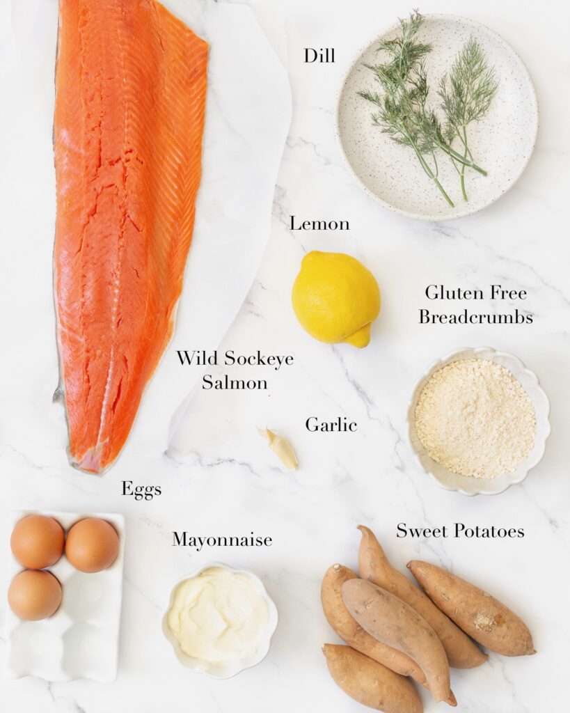 Ingredients for salmon and sweet potato cakes portioned out on a marble slab.