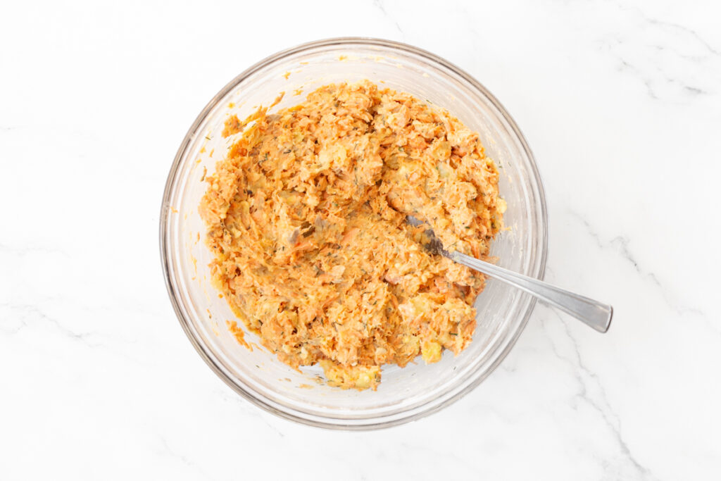 Process shot #2: Salmon cakes mixture, minus the sweet potatoes, mixed in a glass mixing bowl with a fork.