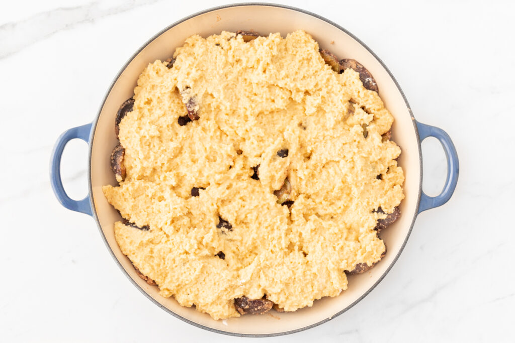 Process shot #3: gluten-free prune plum cobbler assembled in a round baking dish, ready to be baked!